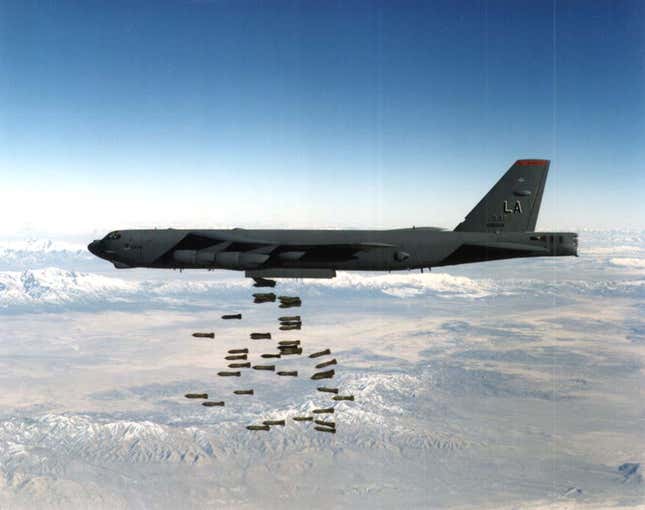 B-52 bomber unloading conventional bombs on a target, location and date unknown.