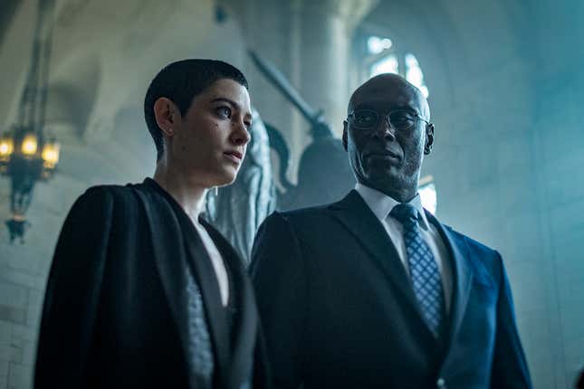 Asia Kate Dillon (as the Adjudicator) and Lance Reddick (as Charon).