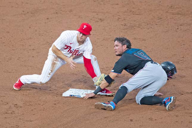 Marlins’ Miguel Rojas gets up close and personal with Phillies’ Scott Kingery during the teams’ 3-game series in Philly. Eleven Marlins have now tested positive for COVID-19.