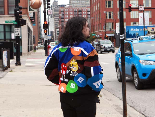 Image for article titled Man Wearing M&amp;M Jacket Apparently Made In God&#39;s Image