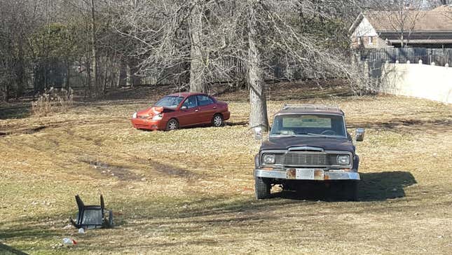 Image for article titled You Haven't Reached Rock Bottom Until You've Got A Totaled Kia Rio Stuck In Your Backyard