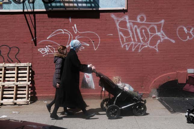 APRIL 10: People walk through an ultra-Orthodox Jewish community in Williamsburg on April 10, 2019 in New York City. As a measles epidemic continues to spread, New York City Mayor Bill de Blasio recently announced a state of emergency and mandated residents of the ultra-Orthodox Jewish community in Williamsburg at the center of the outbreak to get vaccinated for the viral disease. Those who choose not to will risk a $1,000 fine. 