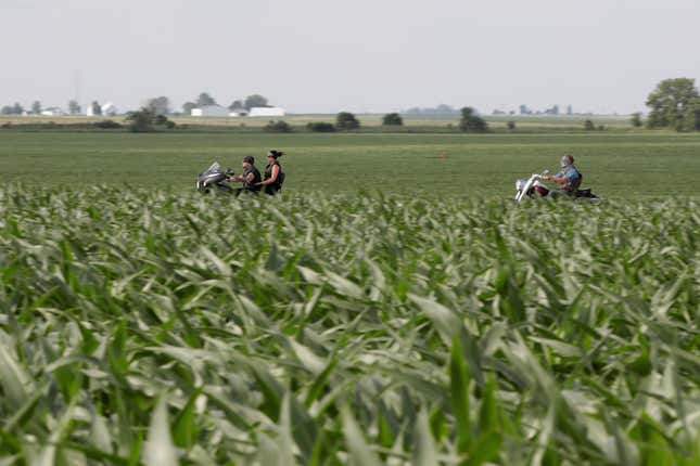 Motorcyclist ride past a cornfield on June 13, 2018 near Dwight, Illinois