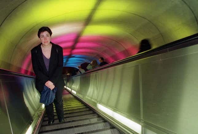 A Metro passenger stares at colored lights projected on the ceiling of the south entrance escalator tunnel of the Dupont Circle Metro station in Washington, D.C., March 16, 2000.