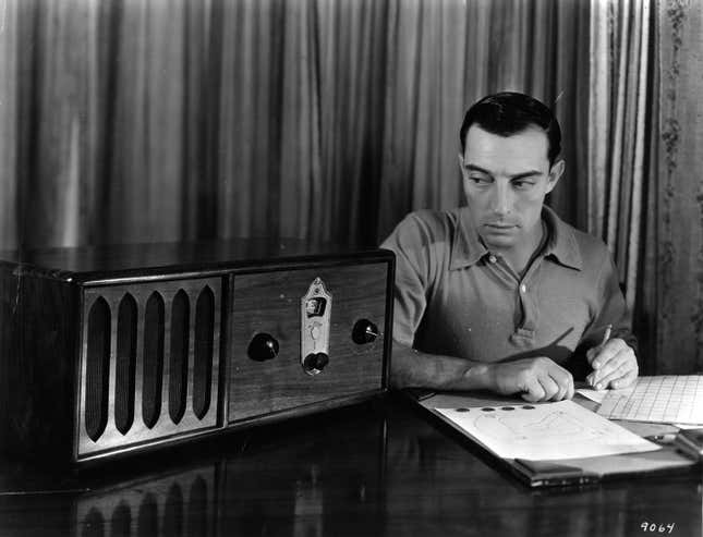 circa 1925: Buster Keaton (1895 - 1966), the American film comedian who started his career in Hollywood in 1917, timing his comedy scripts against radio music.