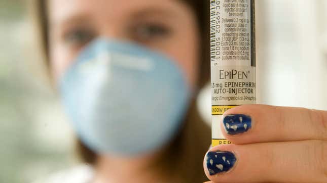 A high school student with severe nut allergies displays an EpiPen and wears a protective mask during an interview in Charleston, West Virginia in 2008.