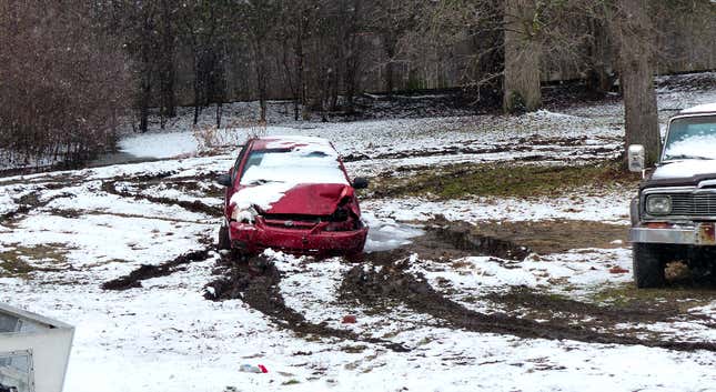 Image for article titled You Haven't Reached Rock Bottom Until You've Got A Totaled Kia Rio Stuck In Your Backyard