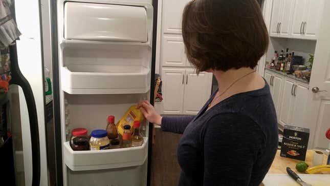 Image for article titled Woman Rearranging Condiments In Refrigerator Door Like Puzzle In Ancient Tomb