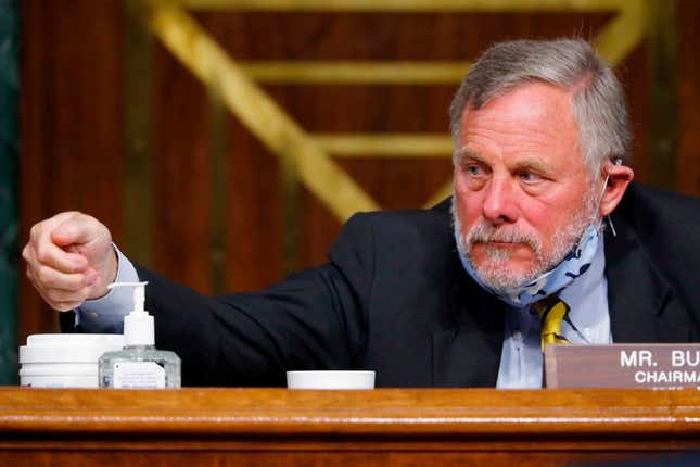 Chairman Richard Burr, R-NC, reaches for hand sanitizer at a Senate Intelligence Committee nomination hearing for Rep. John Ratcliffe, R-TX, on Capitol Hill in Washington,DC on May 5, 2020. - The panel is considering Ratcliffes nomination for Director of National Intelligence.
