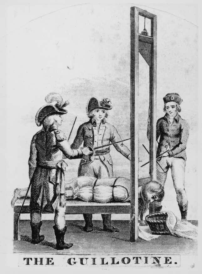 A victim undergoes execution by guillotine during the French Revolution, circa 1793.