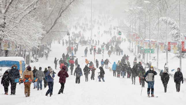 People walk on the snow along Calle de Segovia during heavy snowfall on January 09, 2021 in Madrid, Spain. 
