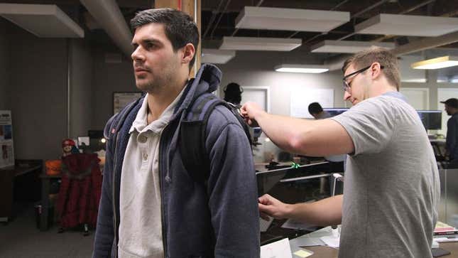 Image for article titled Shamefaced Man Stands Stock-Still As Acquaintance Zips Up Backpack For Him