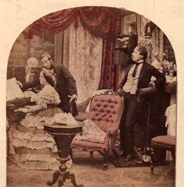 circa 1860: A woman plays the piano in a Victorian parlor.