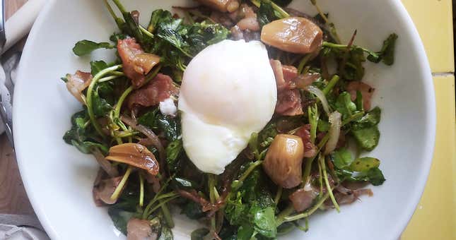 Photo of breakfast salad topped with egg
