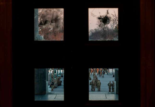 Damage is seen on a door at the US Capitol, from the January 6 riots, as members of the US National Guard arrive outside on January 12, 2021 in Washington, DC.