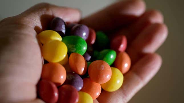 Hand holding pile of Original Skittles in open palm