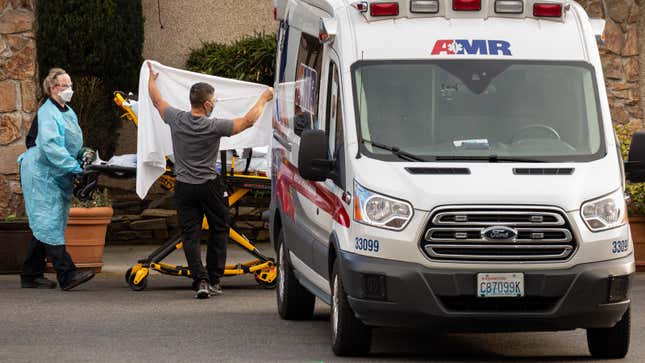 Health care workers transport a coronavirus patient into an ambulance at Life Care Center of Kirkland on February 29, 2020 in Kirkland, Washington.