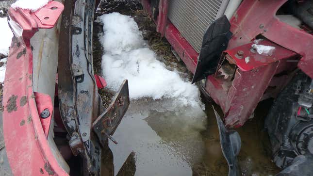 Image for article titled You Haven't Reached Rock Bottom Until You've Got A Totaled Kia Rio Stuck In Your Backyard