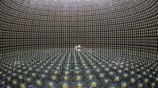 Engineers inside the empty Super-Kamiokande detector in Japan.