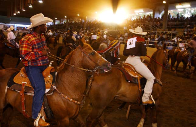 Participants of the 18th annual Bill Pickett Invitational Rodeo ride their horses at the start of the event July 21, 2001 in Los Angeles, CA.