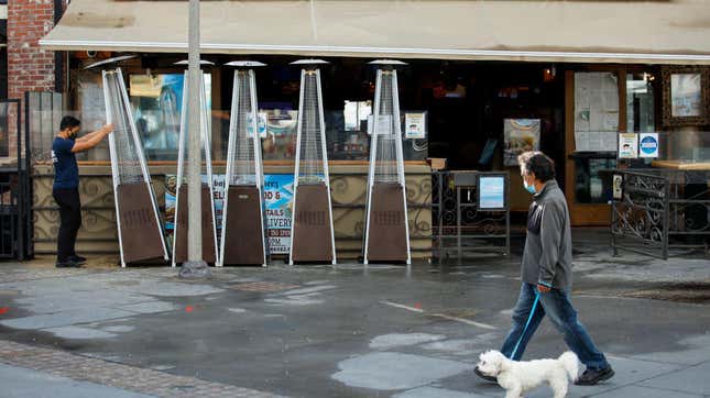 man walking dog in front of restaurant