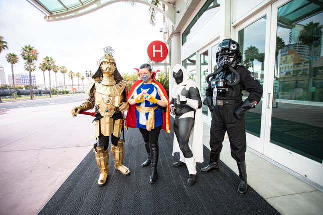 Cosplayers Christopher Canole as Dude Vader, Faeren Adams as Dr. Strange, Derek Shackelton as Moon Knight, and Todd Felton as a TIE pilot pose in front of Hall H at San Diego Convention Center on July 22, 2020 in San Diego, California.