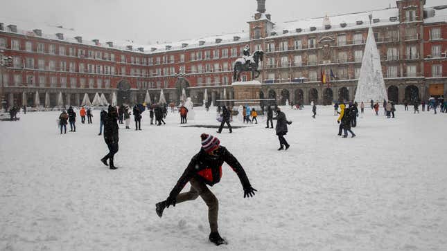 A man throws a snowball at Plaza Mayor during heavy snowfall on January 09, 2021 in Madrid, Spain. 