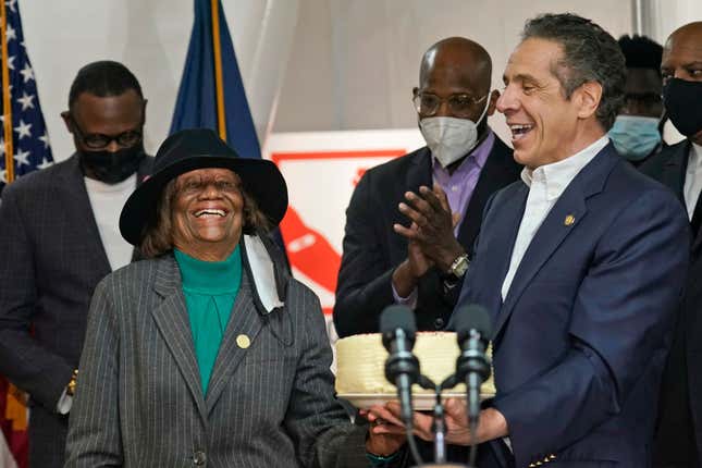 New York Gov. Andrew Cuomo (R) presents Hazel Dukes, president of the New York State chapter of the NAACP, with a cake to celebrate her birthday at the mass vaccination site at Mount Neboh Baptist Church in Harlem on March 17, 2021 in New York City. 