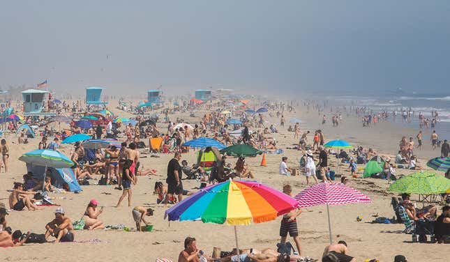 Bañistas disfrutan del calor en la playa de Huntington Beach, California en plena pandemia de Coronavirus (Foto tomada el 25 de abril de 2020).
