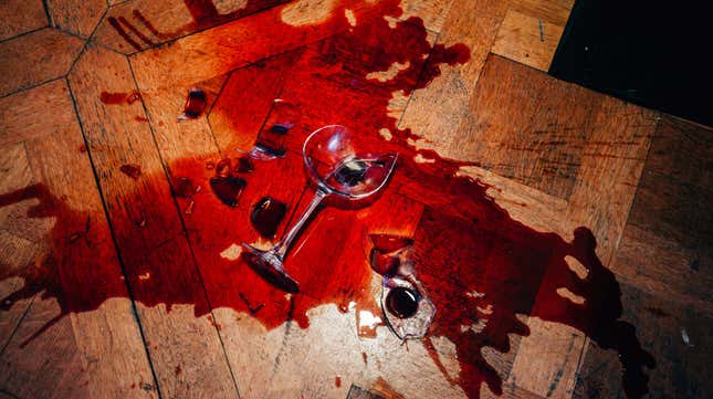 Spilled red wine on wooden floor