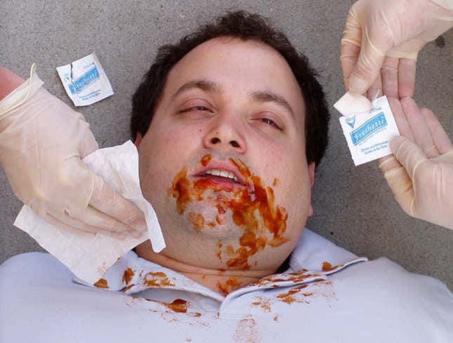 Meatstroke victim Tom Eppard is cleaned by rescue workers.