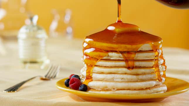 Stack of pancakes covered in syrup