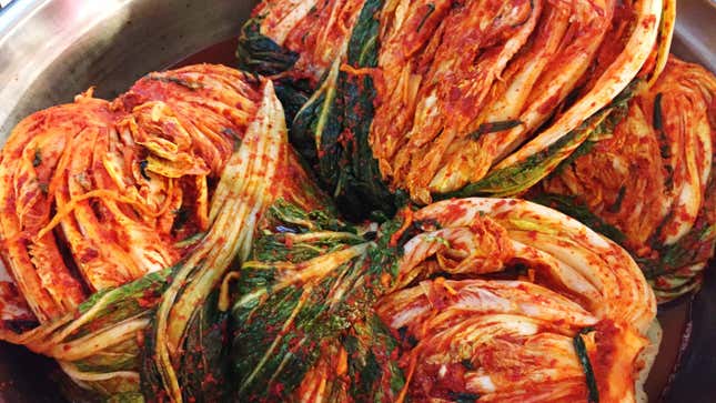 whole heads of cabbage kimchi in bowl