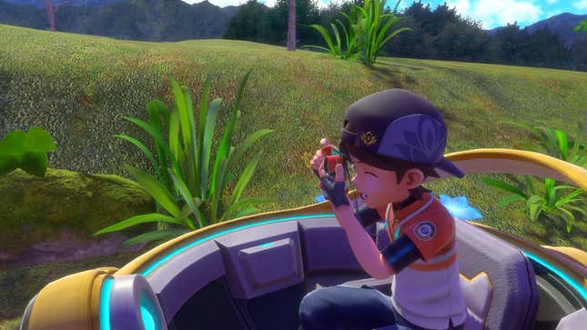 A Pokemon photographer is seen looking through his camera at something off-screen.