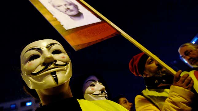 Demonstrators sporting Guy Fawkes masks take part in a protest called by Catalan National Assembly (ANC) under the motto “Journalism is not a crime” to support WikiLeaks founder Julian Assange in Barcelona on February 24, 2020.