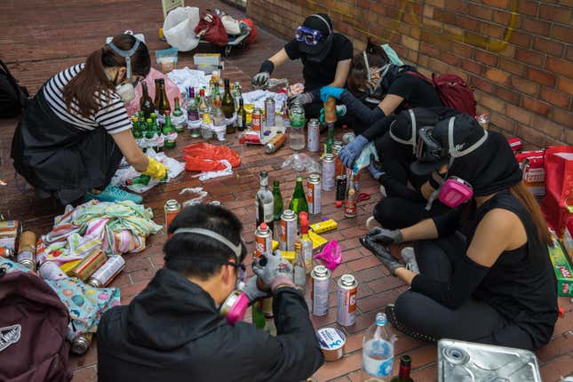 Pro-democracy protesters make molotov cocktails at the Hong Kong Polytechnic University, in Hong Kong on November 14, 2019.