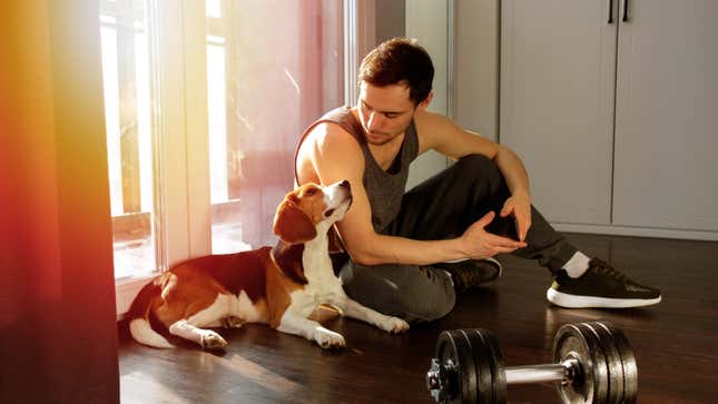 man and puppy preparing to lift some weights