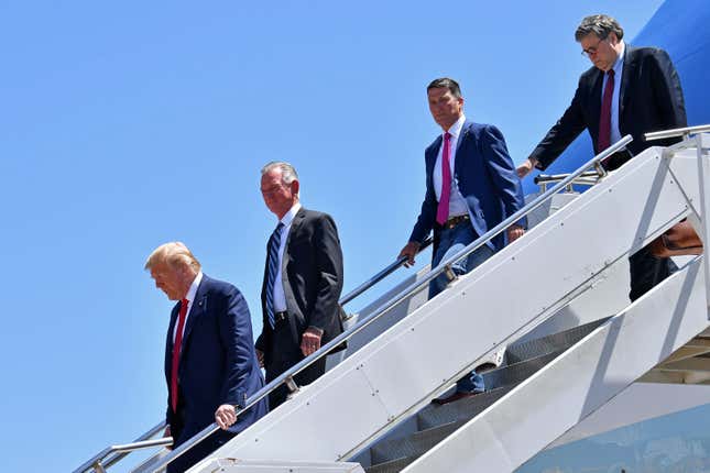 US President Donald Trump steps off Air Force One, alongside US Attorney General William Barr (R), Ronny Jackson (2nd R), Candidate for United States Representative for Texas’s 13th Congressional District, and Tommy Tuberville (2nd L) Candidate for United States Senate from Alabama. 