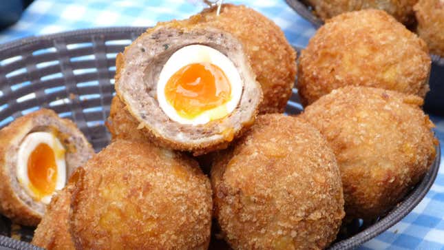 Basket of Scotch eggs with one split open to show cross-section