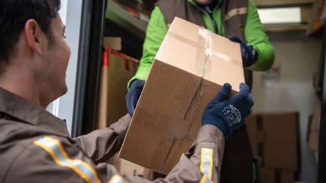 UPS man hands parcel to customer