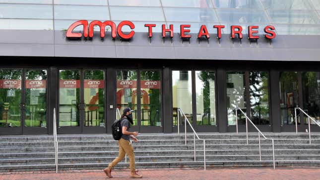 A pedestrian wearing a face mask walks by AMC Theatres amid the coronavirus outbreak in Washington, DC. 