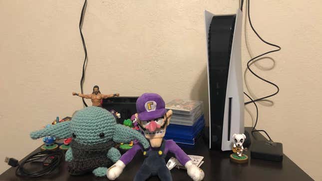 a photo of the playstation 5 next to waluigi baby yoda and kk slider