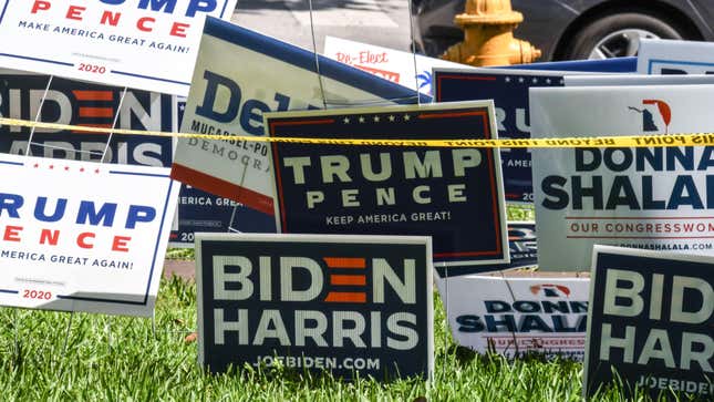 Trump-Pence and Biden-Harris signs are displayed outside The Coral Gables Branch Library in Miami, Florida on October 27, 2020.