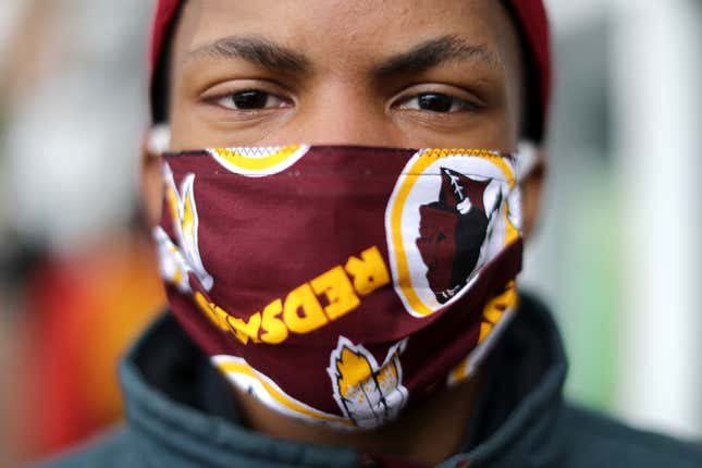 JoJo Houston wears a Washington Redskins face mask while helping Martha’s Table distribute hundreds of free hot meals donated by the Clyde’s Restaurant Group to people in need during the novel coronavirus pandemic, which has forced many people out of work and unable to reach healthy food, April 01, 2020 in Washington, DC. 