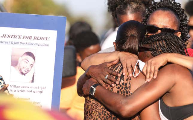Debra Ray (L), aunt of Dijon Kizzee, is embraced after speaking near a makeshift memorial where Dijon Kizzee, a 29-year-old Black man, was killed by Los Angeles sheriff’s deputies in South Los Angeles on September 1, 2020 in Los Angeles, California. Protesters marched to the South Los Angeles Sheriffs’ Station to demonstrate for a second day after Kizzee was killed in an altercation after being stopped by police while riding his bicycle.