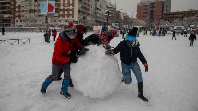 People make a big snowball at Las Ventas during heavy snowfall on January 09, 2021 in Madrid, Spain. 