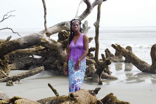 Queen Quet stands among damaged trees on Hunting Island, S.C.