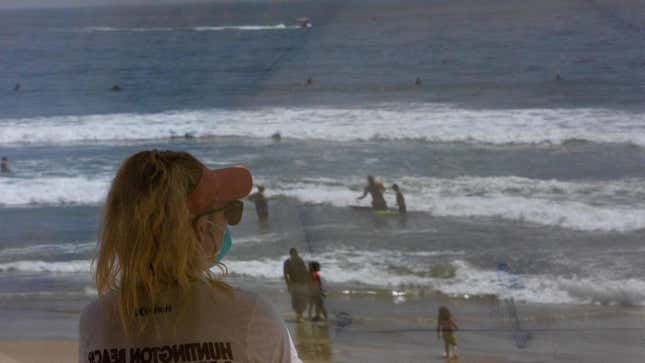Not even beaches offer the same relief they did pre-pandemic. In Huntington Beach, California, this lifeguard opted for a face mask.