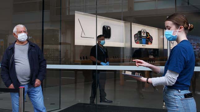 A staff member assists a customer prior to entering the Bondi Junction Apple Store on May 07, 2020 in Sydney, Australia. 