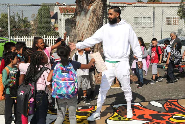 Nipsey Hussle greeting kids at an event to reveal a neighborhood basketball court he had worked to have refurbished, Oct. 22, 2018, in Los Angeles.